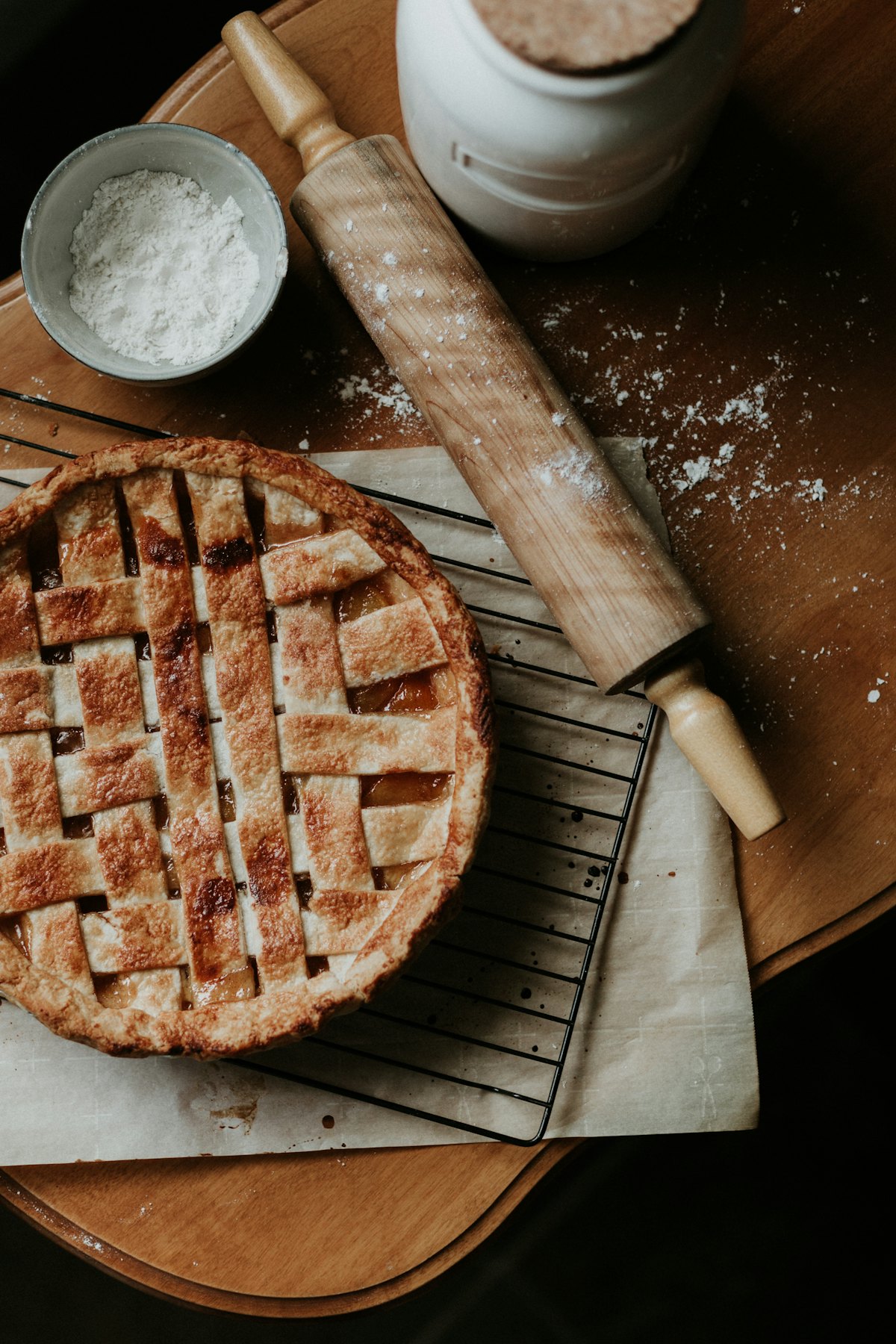 Pastry cooling on a wire rack beside a floured rolling pin