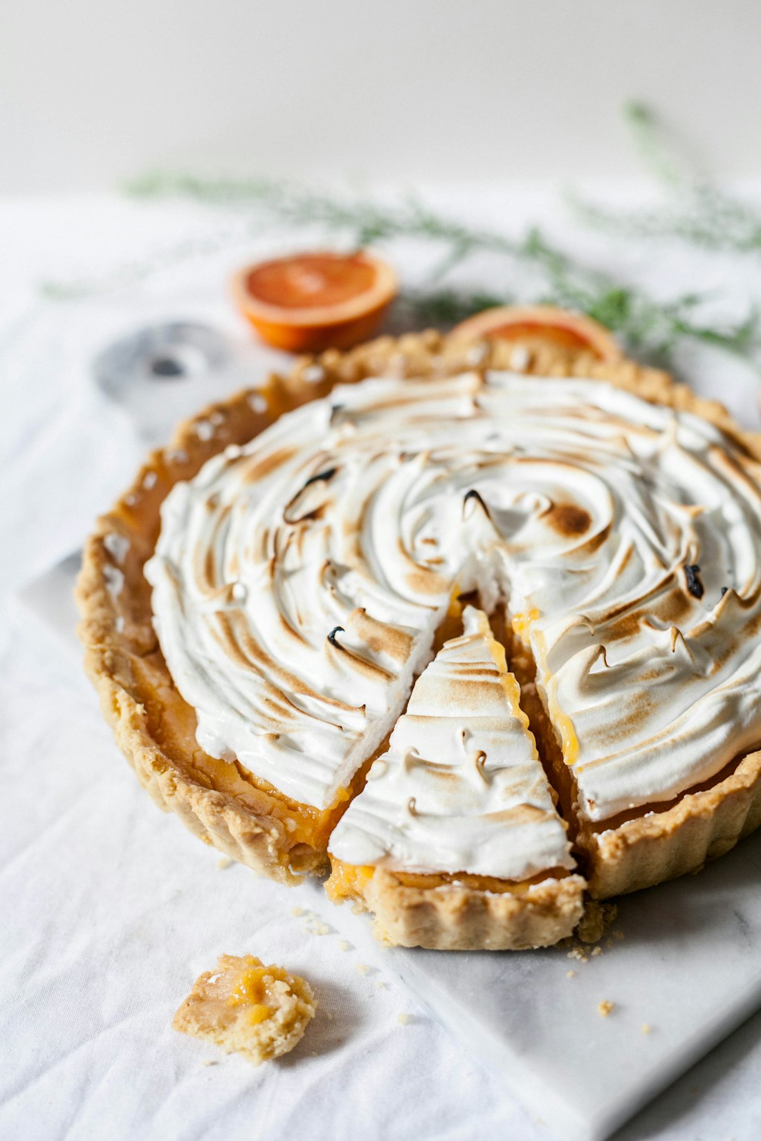 A lemon meringue tart with a slice removed