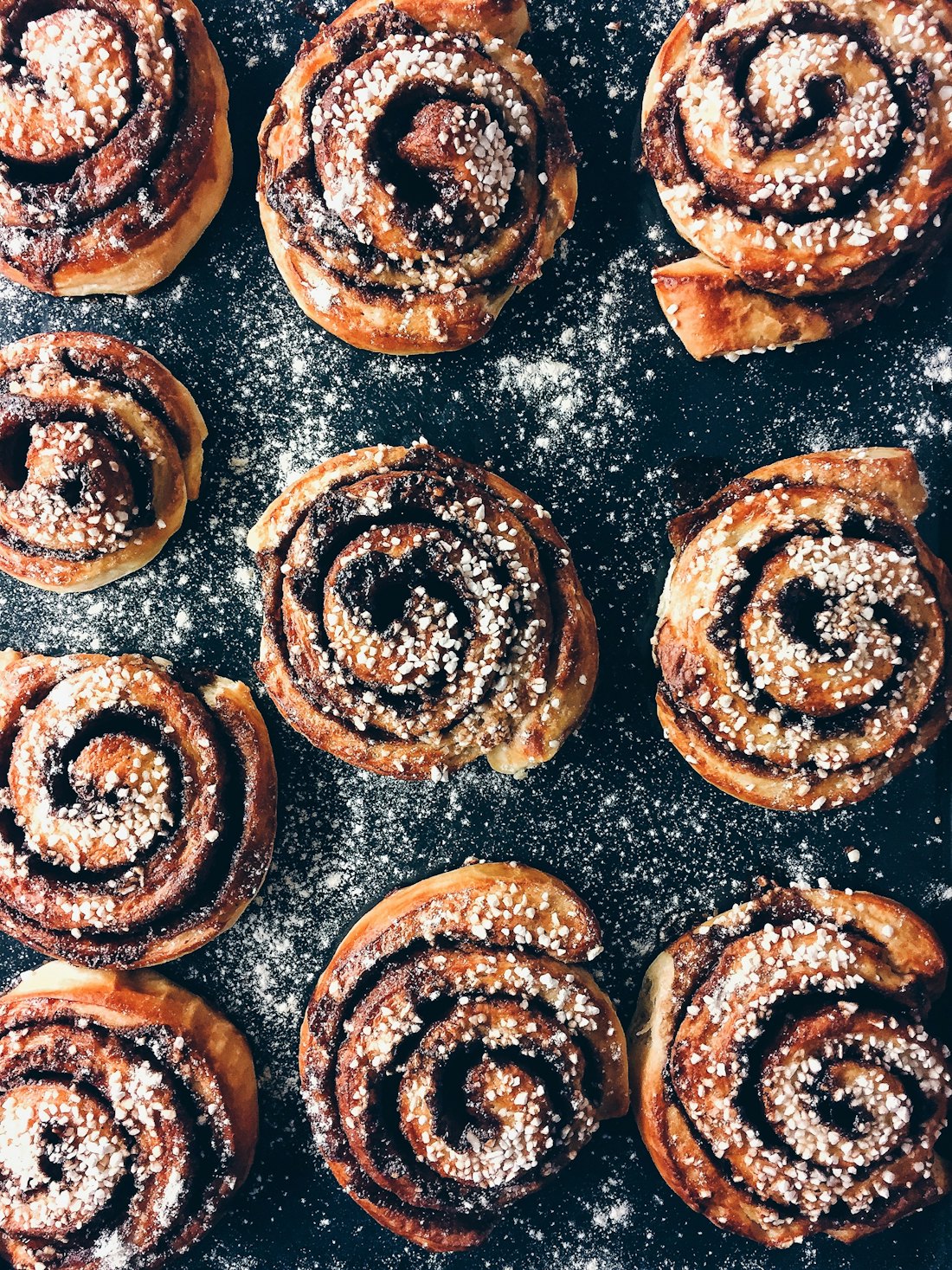 A tray of cinnamon scrolls seen from above